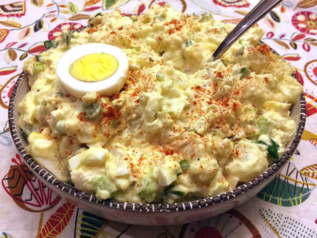 Classic creamy potato salad with smooth dressing, tender potatoes, fresh parsley, and crunchy red onion