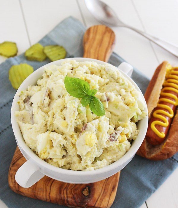 Southern potato salad with eggs, tender potatoes, creamy dressing, fresh herbs, crunchy celery, vibrant color