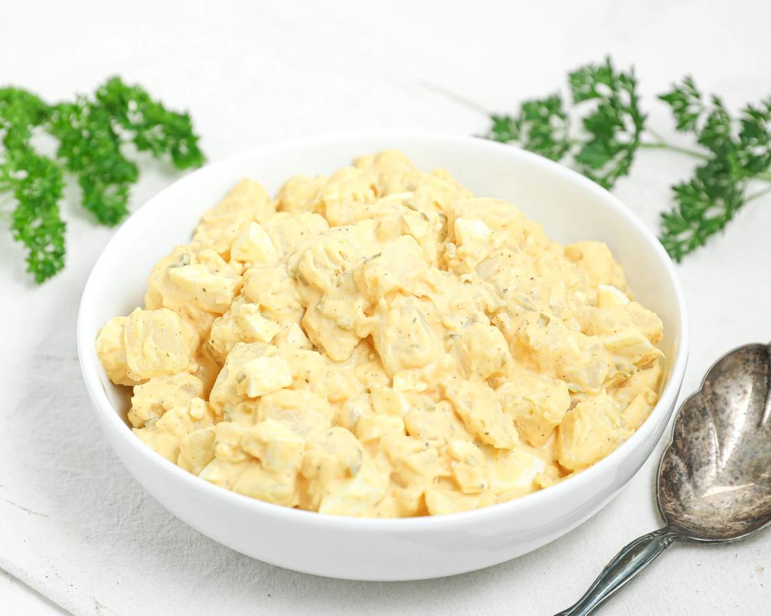 Southern potato salad with eggs, creamy dressing, fresh herbs, crunchy celery, golden potatoes