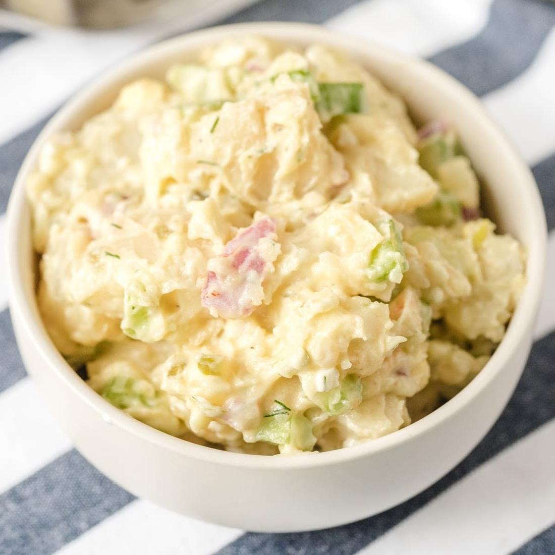 Classic creamy potato salad with tender potatoes, creamy dressing, crunchy celery, and fresh herbs