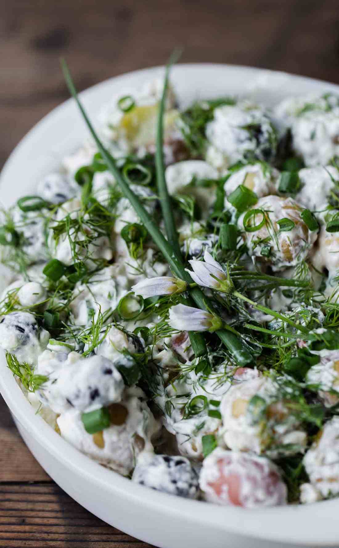 Creamy dill potato salad with tender potatoes, fresh herbs, and crisp celery, perfect for picnics