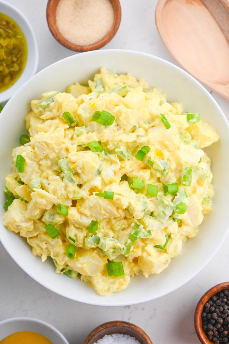Classic creamy potato salad featuring tender potatoes, smooth dressing, fresh herbs, and crunchy celery
