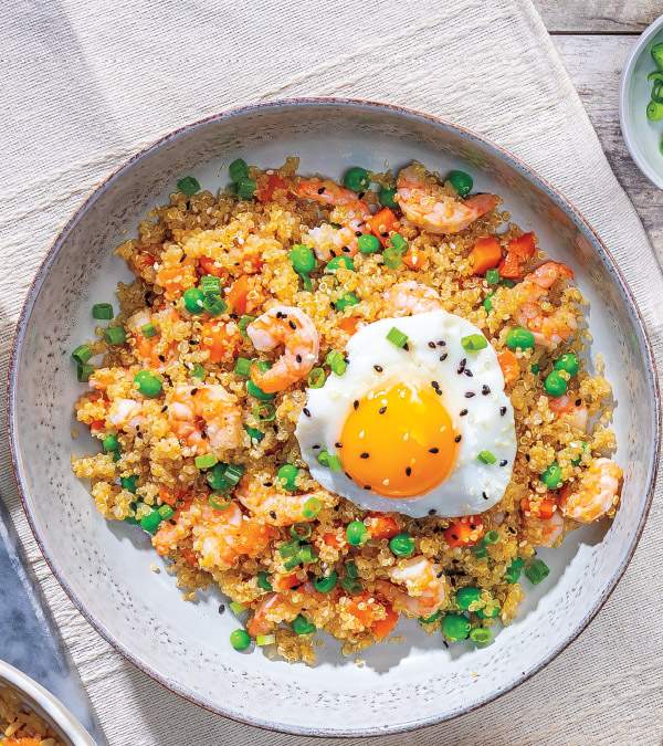 Shrimp quinoa fried rice with fluffy grains, pink shrimp, colorful veggies, and a glossy soy glaze