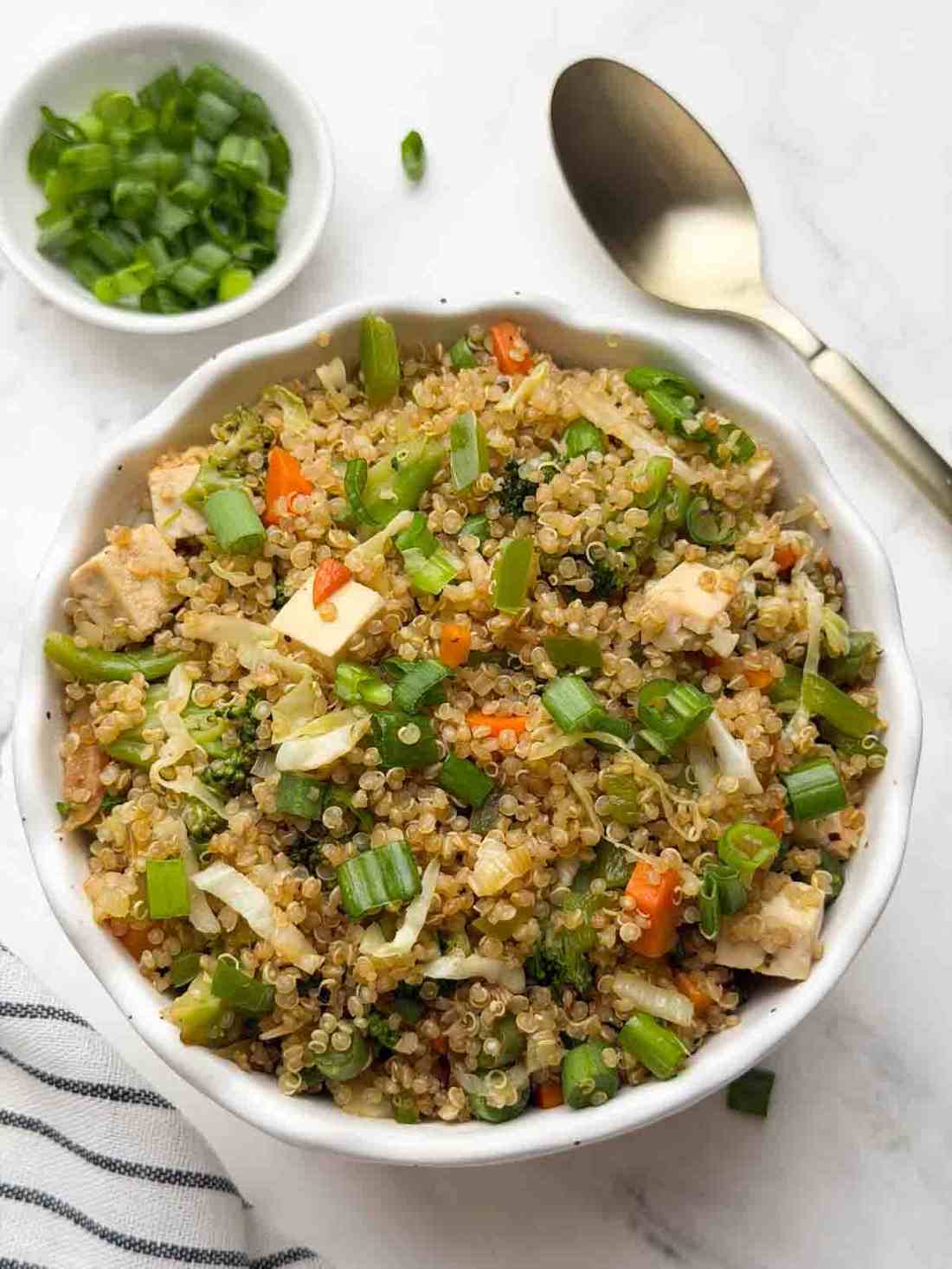 Crispy egg quinoa fried rice with golden fried egg and soy glaze.