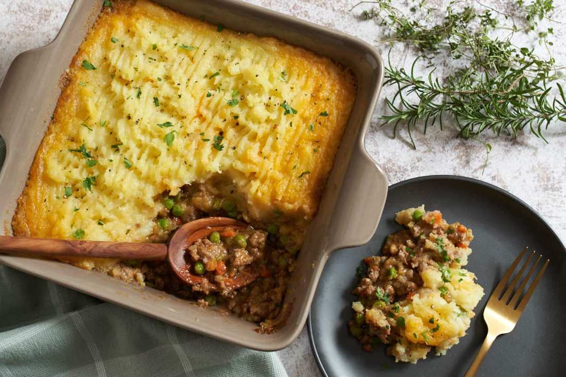 Golden mashed potato topped homestyle shepherd's pie with savory beef filling, bubbling cheese