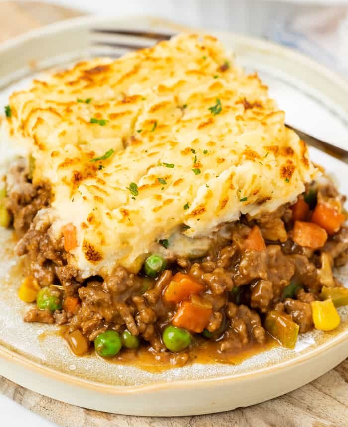 Homestyle shepherd's pie, golden mashed potato topping, savory lamb filling, bubbling cheese, warm casserole dish