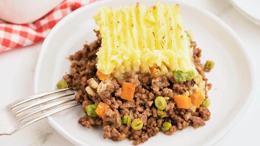 Cozy shepherd's pie, herb‑infused mashed topping, savory beef filling, bubbling cheese, warm casserole dish