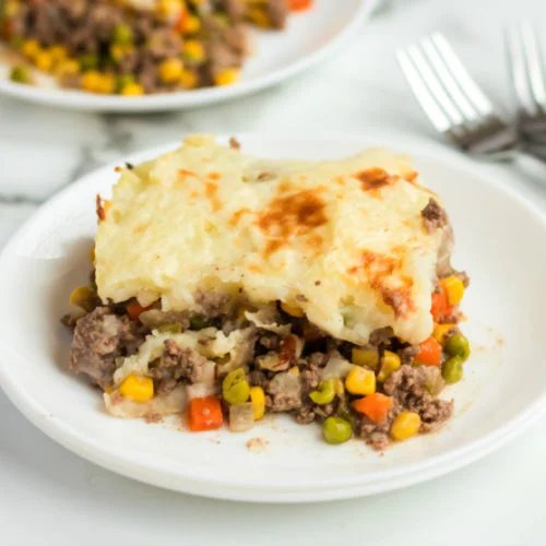 Golden mashed potato crowned homestyle shepherd's pie with savory beef filling, bubbling cheese, warm casserole