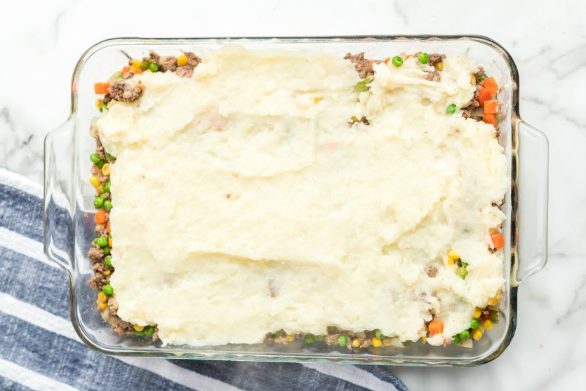 Golden mashed potato crowned homestyle shepherd's pie with savory beef filling, bubbling cheese, warm casserole