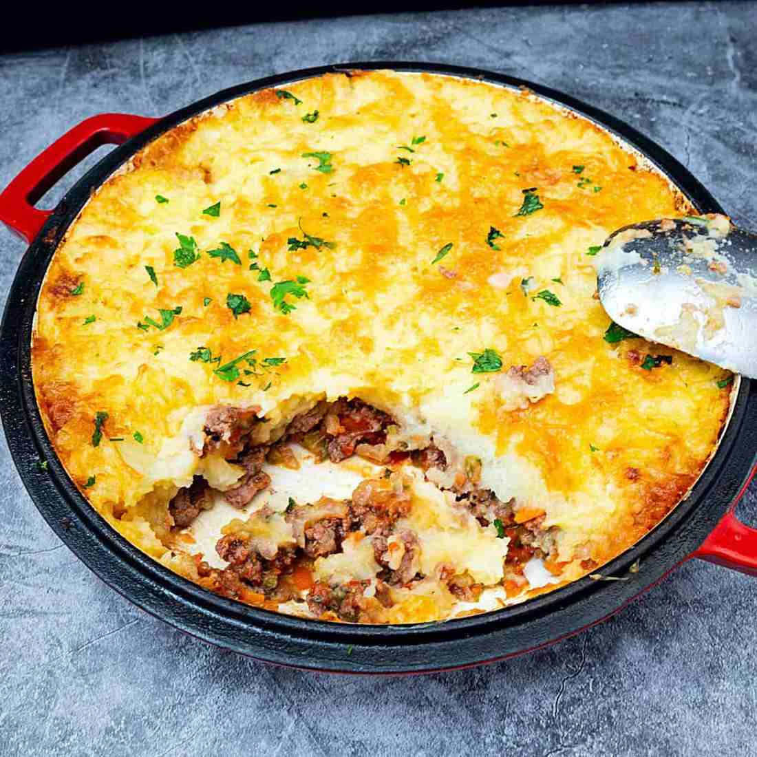 Golden mashed potato crowned ground beef cottage pie with savory filling, bubbling cheese, warm casserole