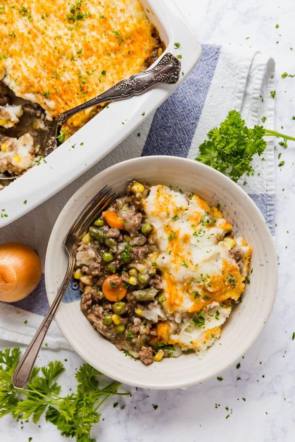 Golden mashed potato‑topped homestyle shepherd’s pie with savory beef filling, bubbling cheese, warm casserole