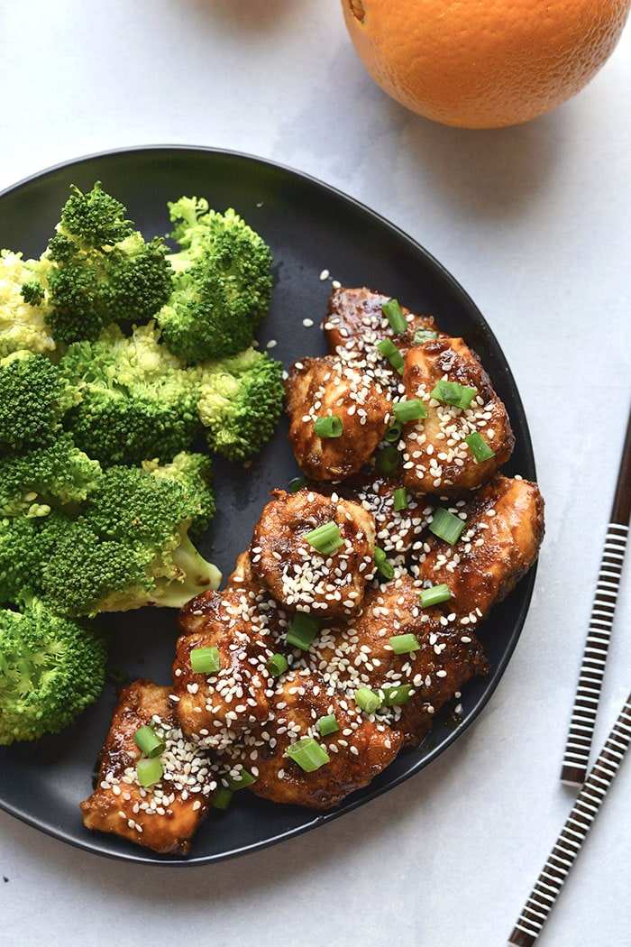 Orange‑glazed chicken topped with fresh pineapple chunks and a drizzle of orange sauce