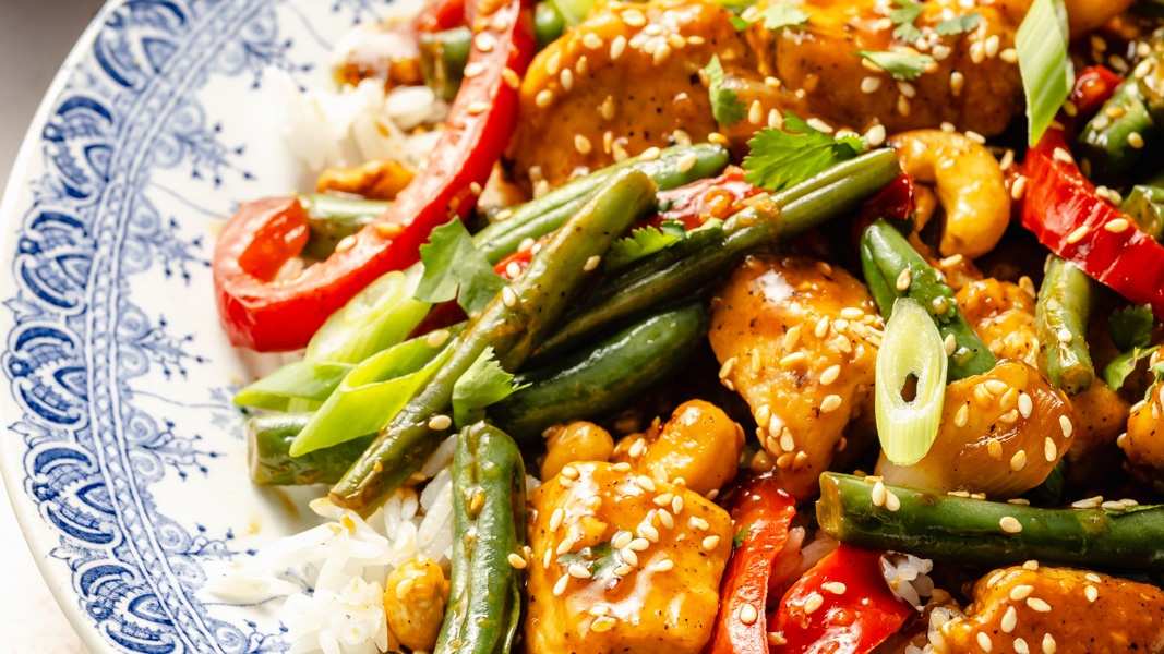Tender orange‑glazed chicken stir‑fry with bell peppers and a glossy citrus sauce