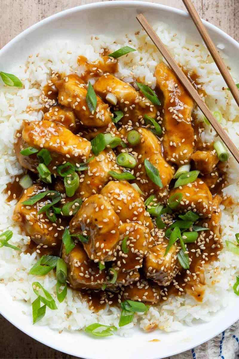 Crispy orange‑glazed skinny chicken nuggets from the air fryer with fresh orange garnish