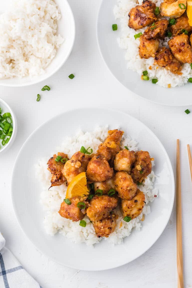 Orange‑glazed skinny chicken and roasted veggies from the air fryer with fresh orange garnish