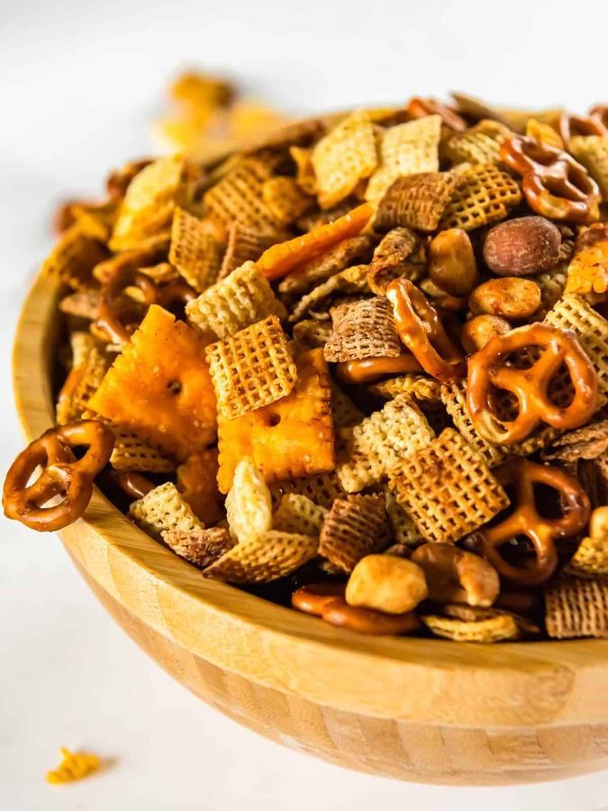 Golden classic Chex mix with pretzels, peanuts, butter, and savory glaze