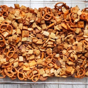 Classic slow cooker chex party mix with crunchy Chex cereal, pretzels, nuts, savory butter coating, and buttery aroma
