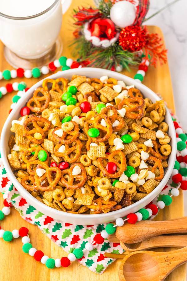 Festive Christmas Chex mix with pretzels, pecans, cinnamon, butter, and holiday spices