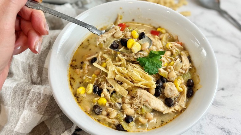 Restaurant‑style chicken tortilla soup with robust tomato broth, shredded chicken, crispy tortilla strips, avocado, and lime