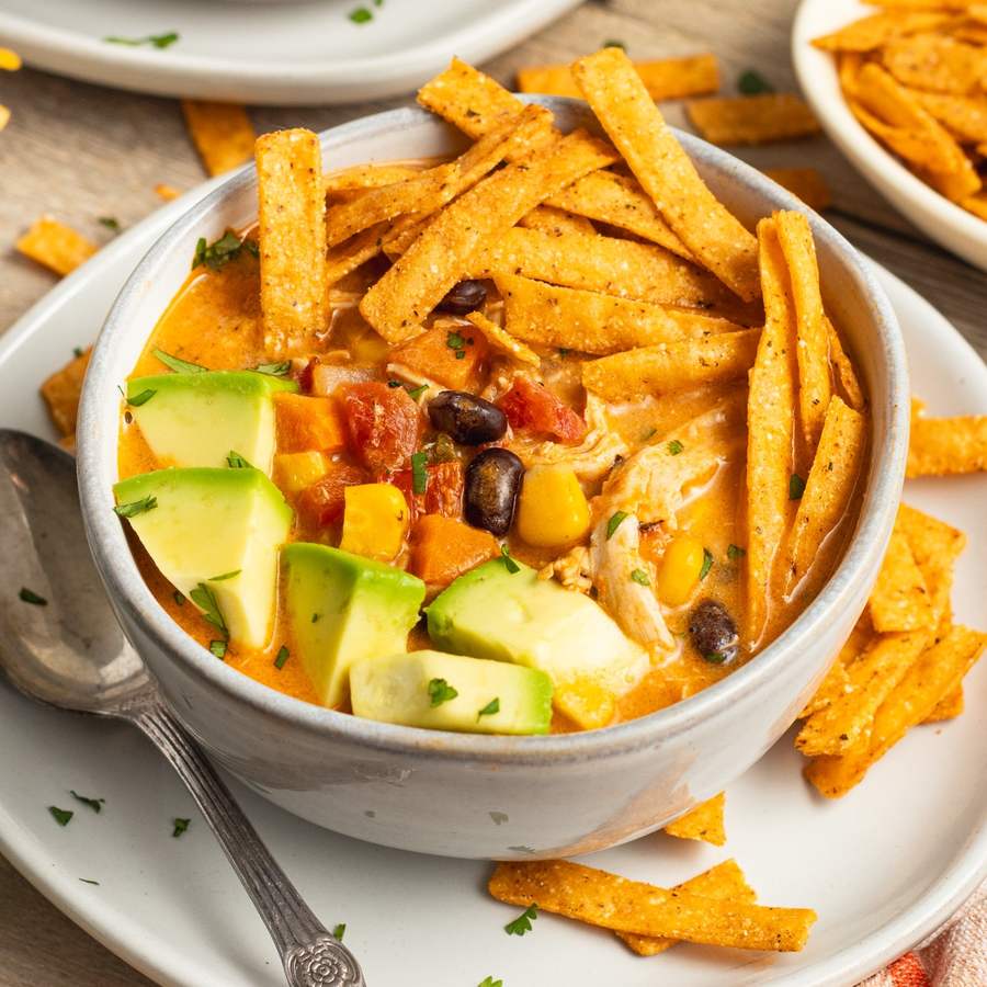 Creamy sweet‑heat chicken tortilla soup with balanced broth, shredded chicken, crispy tortilla strips, avocado, and lime