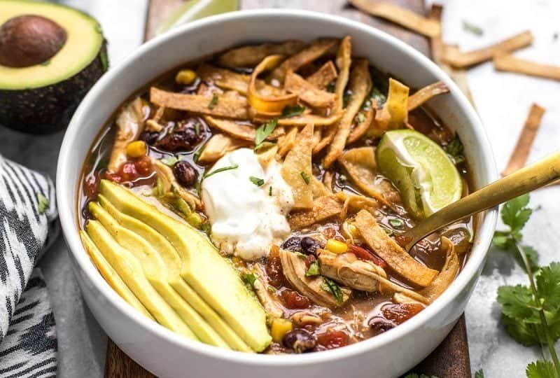 Smoky chipotle chicken tortilla soup, rich tomato broth, shredded chicken, crunchy tortilla strips, lime, avocado