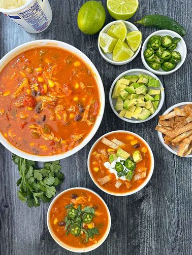 Chicken tortilla soup, cilantro‑lime broth, shredded chicken, crispy tortilla strips, avocado, lime wedge