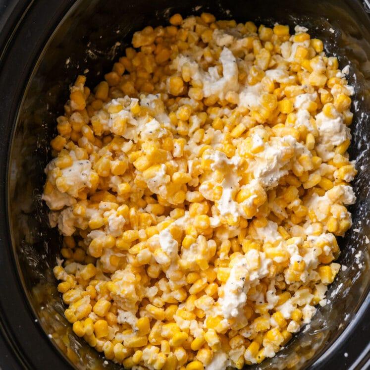 Creamy slow cooker creamed corn with sweet kernels, buttery sauce, and a touch of herbs, a comforting side.