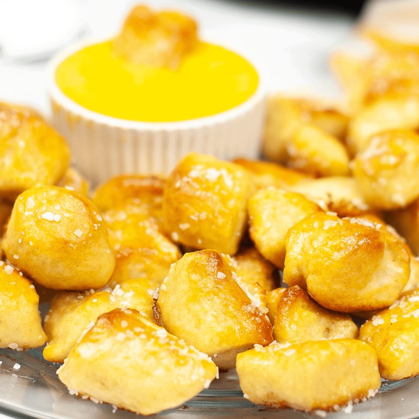 Golden soft pretzel bites from an air fryer, served with a creamy dip