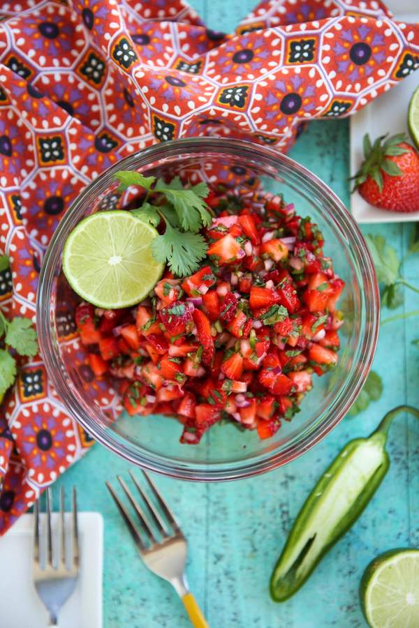 Classic fresh strawberry salsa with diced strawberries, red onion, cilantro, and lime, served in a clear bowl