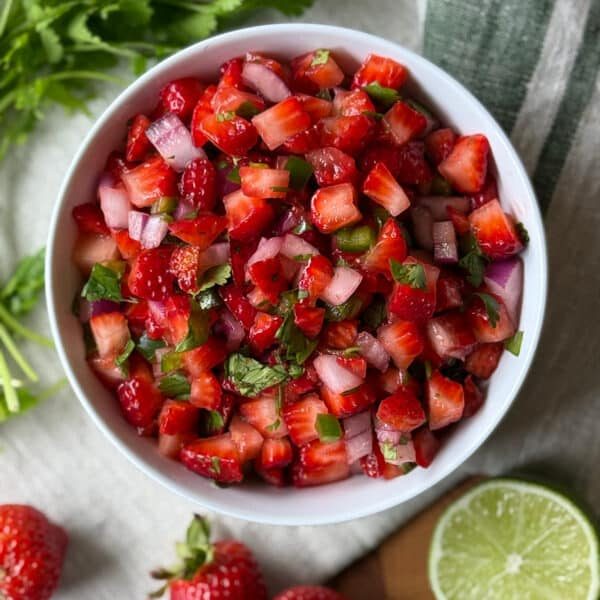 Classic fresh strawberry salsa with diced strawberries, lime, cilantro, and a dash of honey