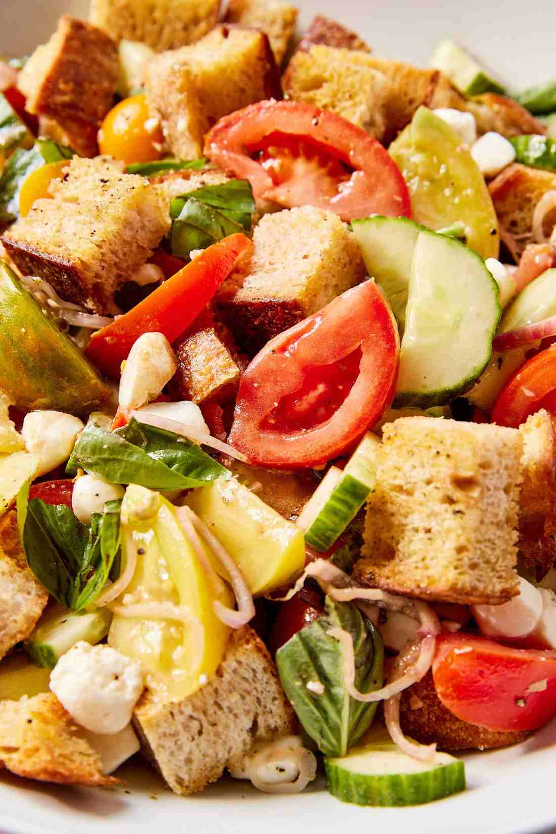 Classic summer panzanella with crusty bread cubes, ripe tomatoes, basil, mozzarella, and a bright vinaigrette