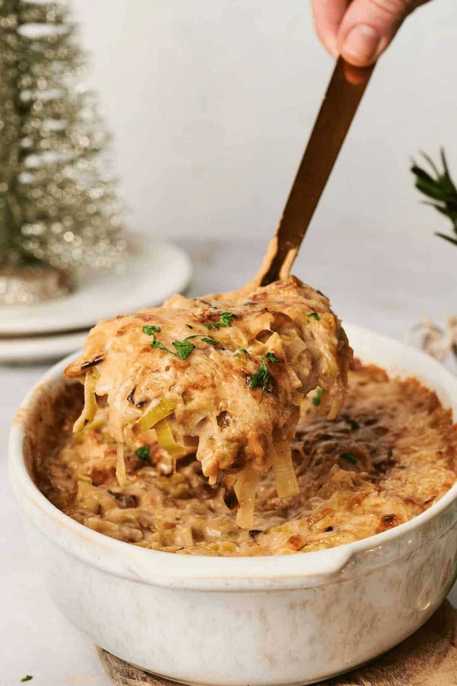 Fluffy whipped mashed potatoes with visible flecks of herbs and a smooth, creamy texture in a bowl.